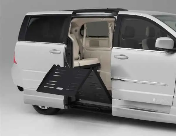 Silver wheelchair van with fold-out ramp coming out of van